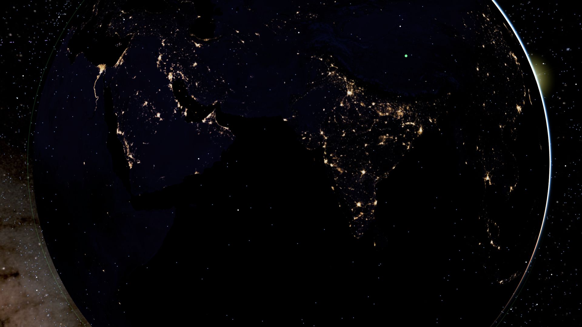 India at night from orbit on the 3D globe, its cities lit up, dawn at the edge of the Earth